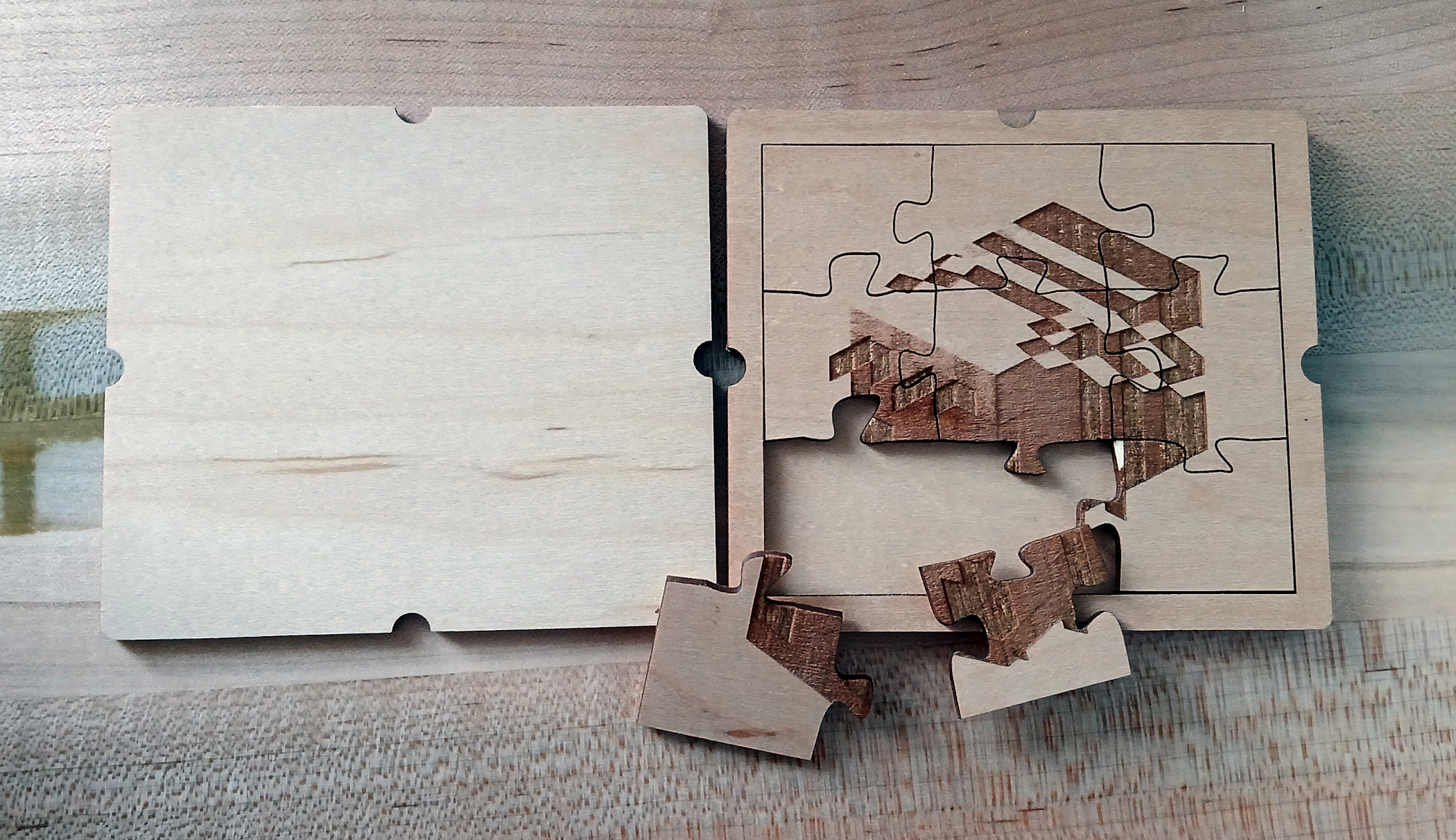 A nine piece puzzle made out of laser engraved plywood. The image on the puzzle is a blocky bee.