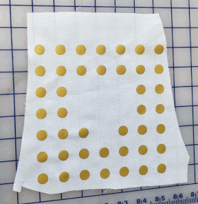 A gif demonstrating using the registration marks to align the heart with the dots during heat transfer.