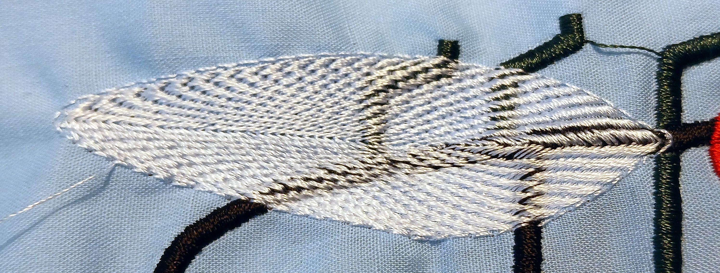 An oblong shape is filled with stitches that spiral into the center from the outside.