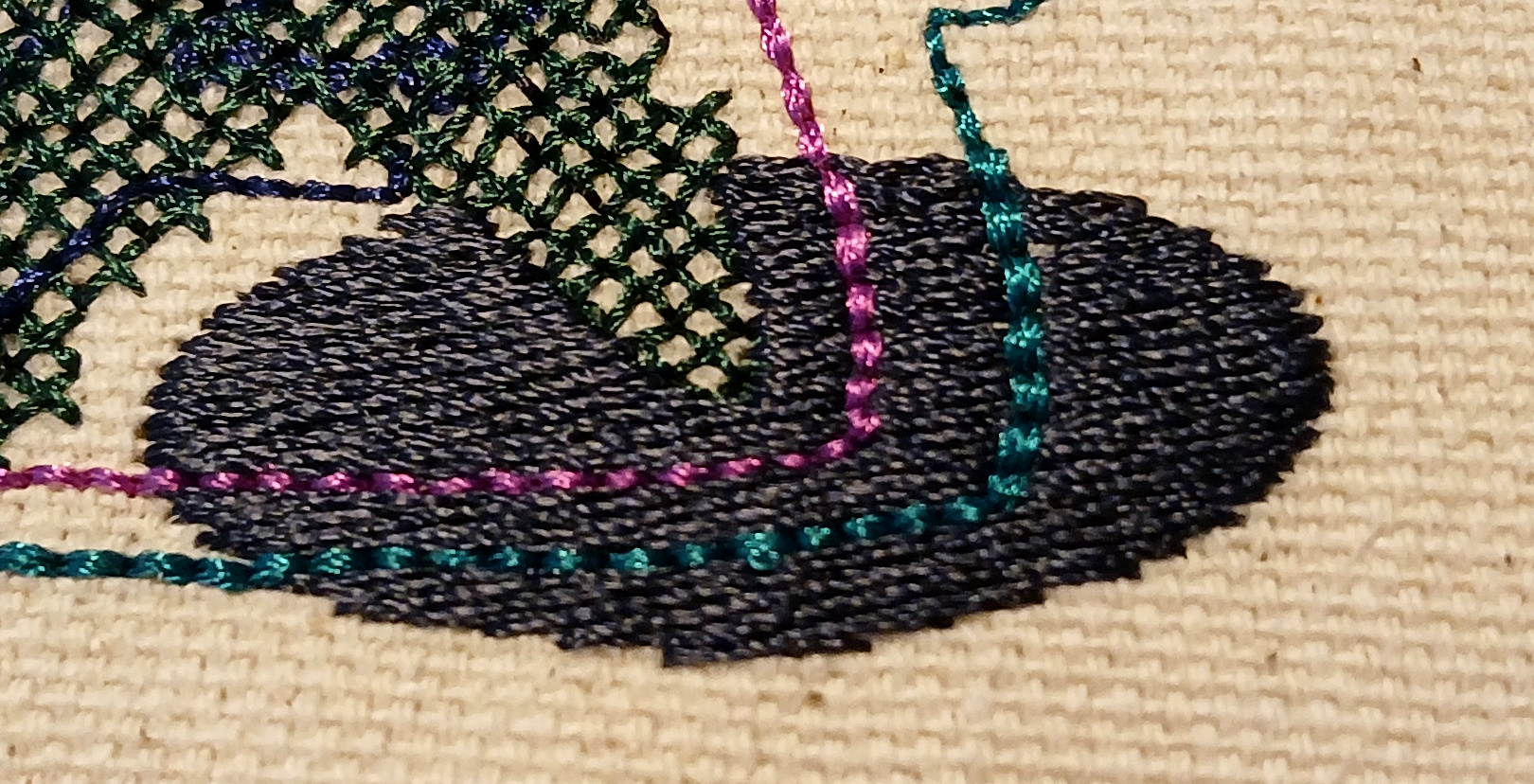 An oblong shape is filled with parallel stitches that create a smooth surface.